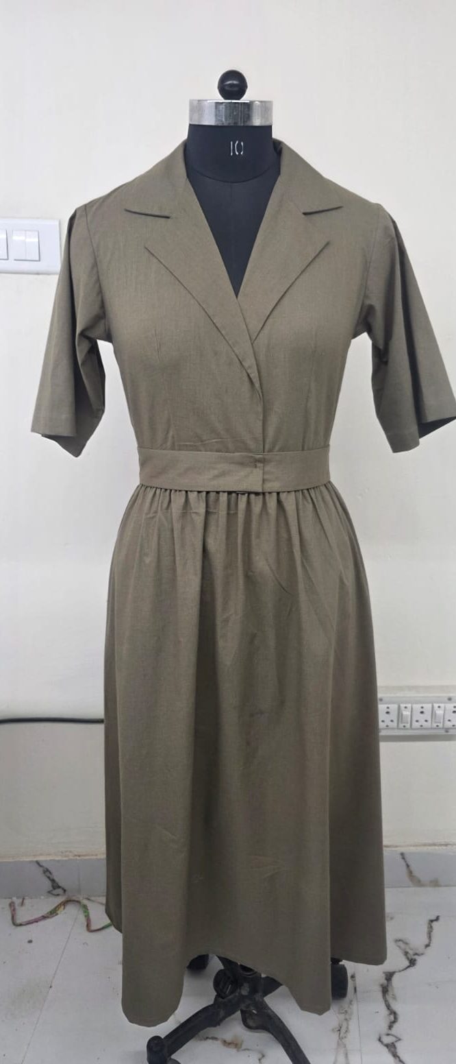 An olive cotton dress with a notched collar and gathered waist seam.